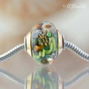 Handmade Lampwork glass art bead with encased murrini